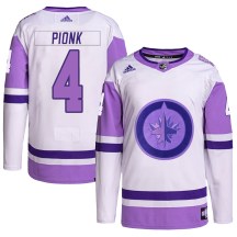 Winnipeg Jets Youth Neal Pionk Adidas Authentic White/Purple Hockey Fights Cancer Primegreen Jersey